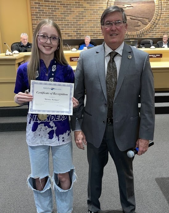 Grand Island Senior High bowler receiving a certificate from Mayor Steele