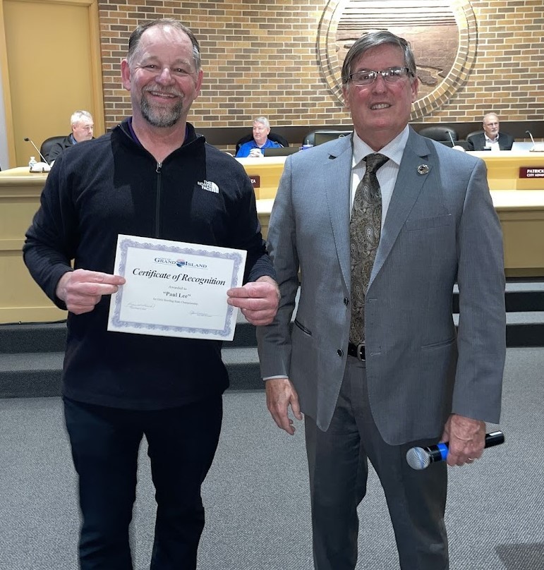 Grand Island Senior High bowler receiving a certificate from Mayor Steele