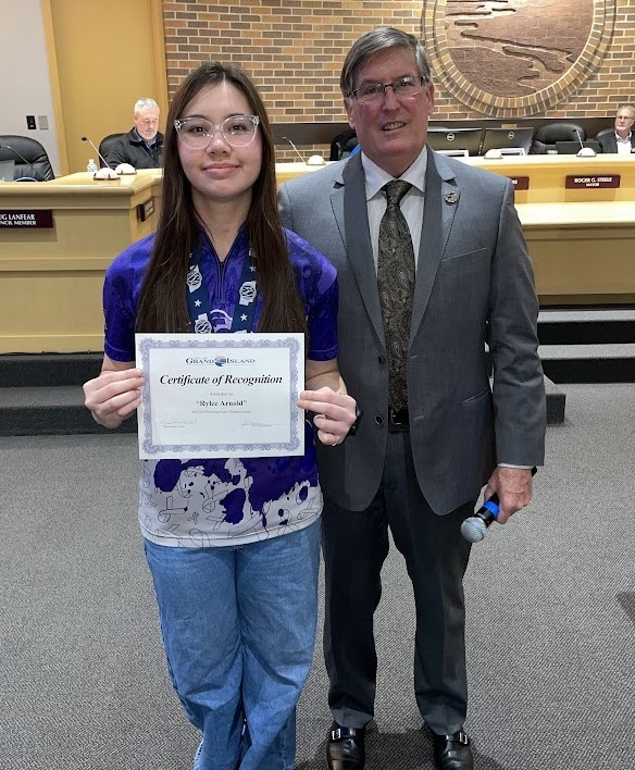 Grand Island Senior High bowler receiving a certificate from Mayor Steele