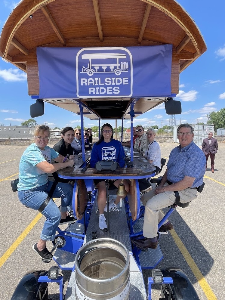 Several people are seated for the first-ever Railside Ride
