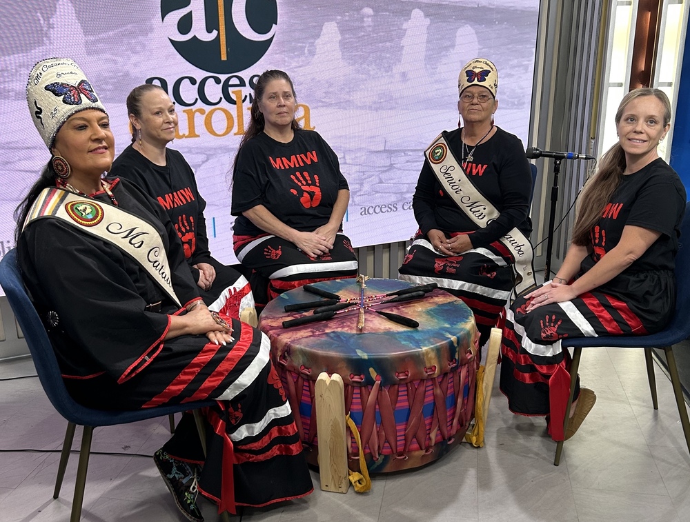 Picture shows female drummers from the Catawba Nation around a large drum