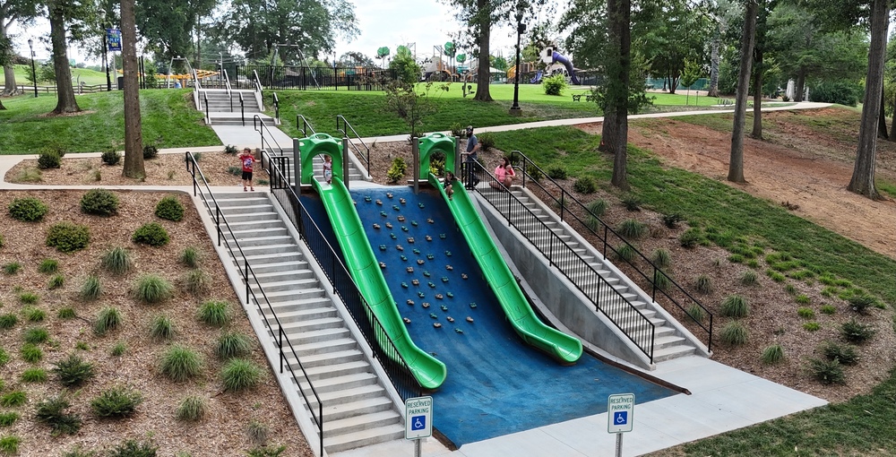 Picture shows the new stairs railings and landscaping around the hillside slides and climbing wall at Century Park
