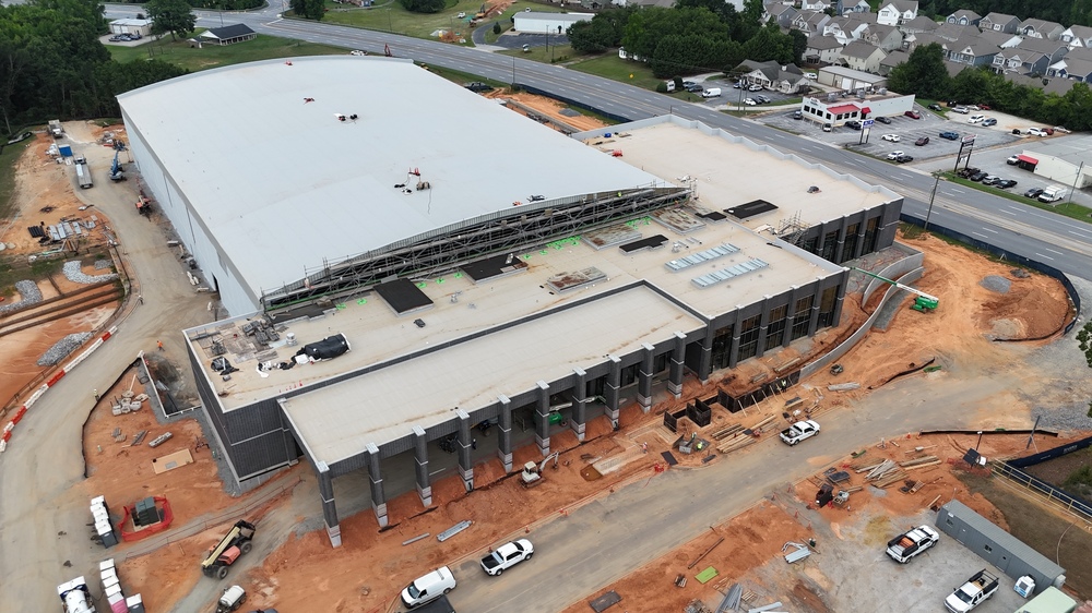 Aerial photo of the City of Greer's Sports & Events Center showing Highway 14 and the driveway with various cars parked along path