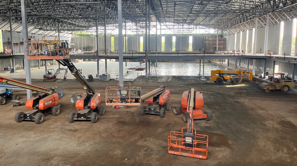 Picture shows construction of the gym floor and walking track inside the City of Greer's new Sports and Events Center