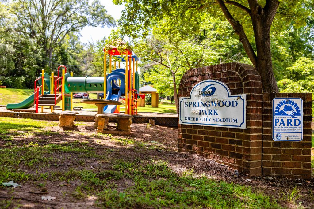 Springwood Park Sign with Playground in Background