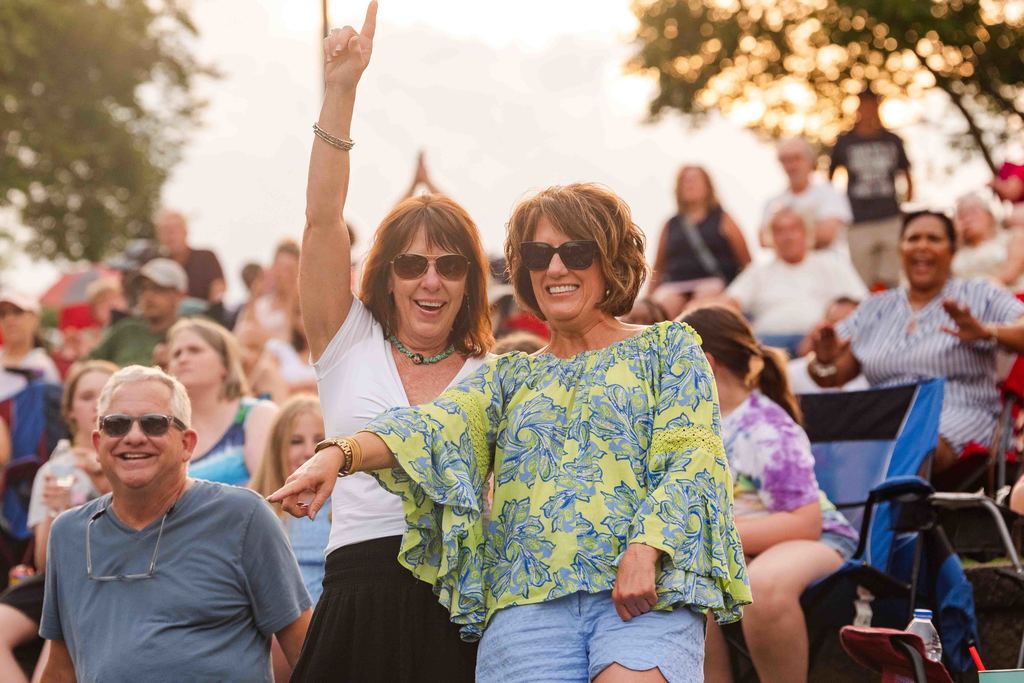 Women Pose for Camera at Tunes in the Park