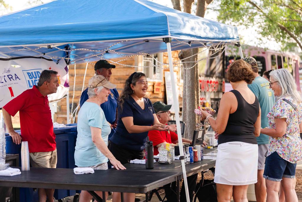Tunes in the Park Goers at Food Vendor Table