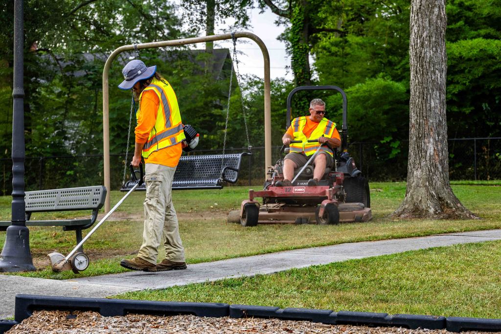 Public Service Workers use Mower and Edge Sidewalk at Greentown Park