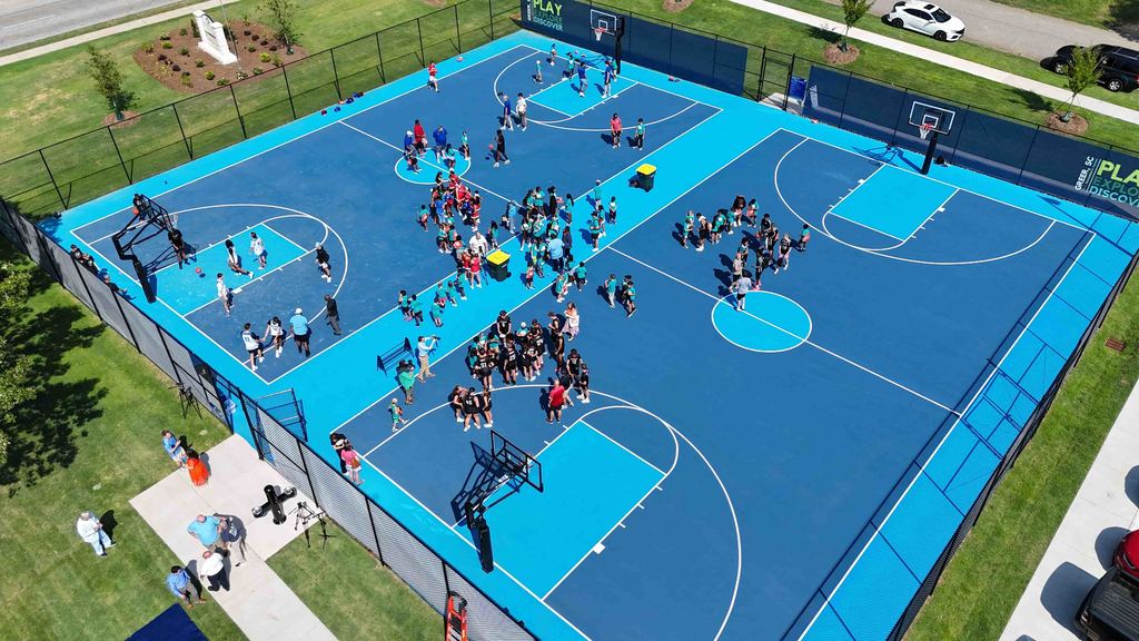 Drone shot of Kids on Basketball Courts for Stevens Courts Ribbon Cutting