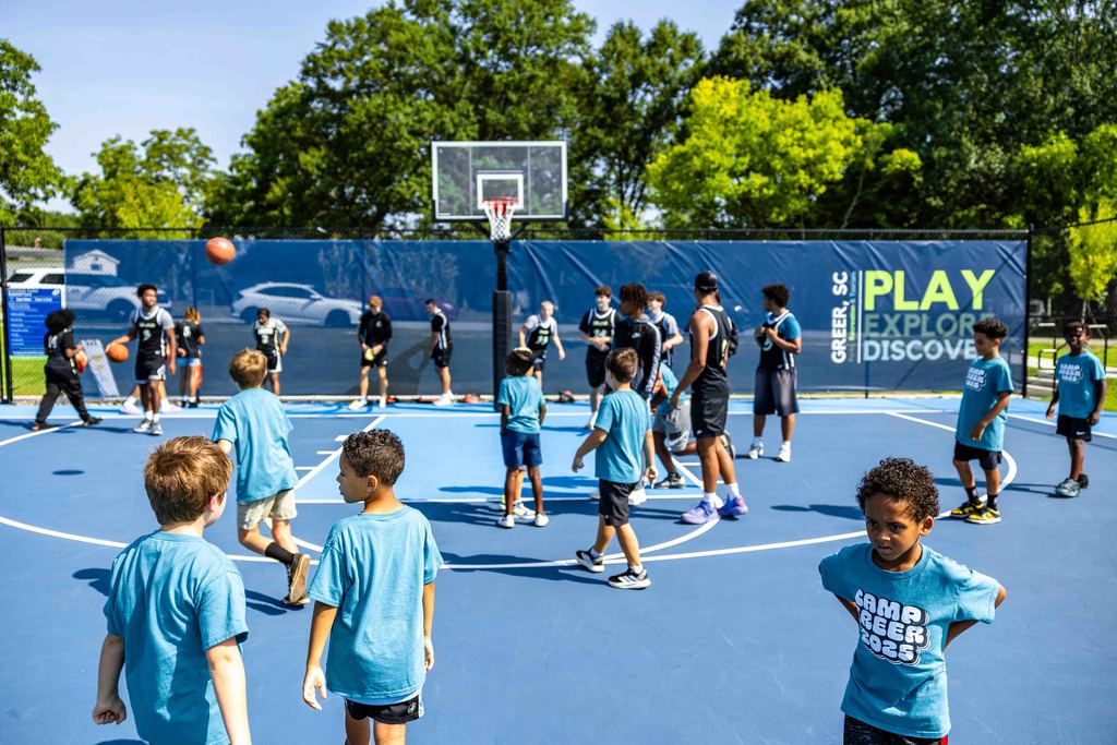 Wide shot of Kids on Basketball Courts for Stevens Courts Ribbon Cutting