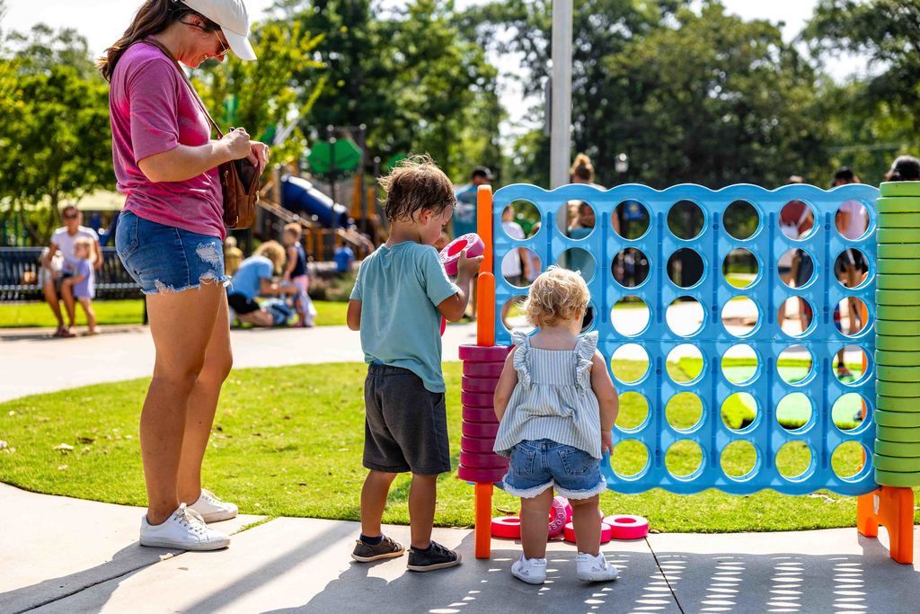 Kids play with giant Connect 4 Set at Park Hop Playdate