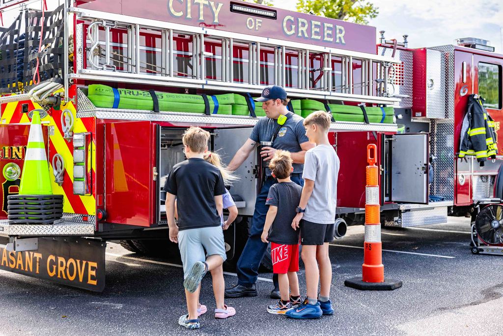 Greer Firefighter shows Fire Truck at Park Hop Playdate