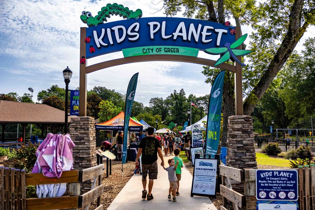 Dad and Sons Walk into Kids Planet during Park Hop Playdate