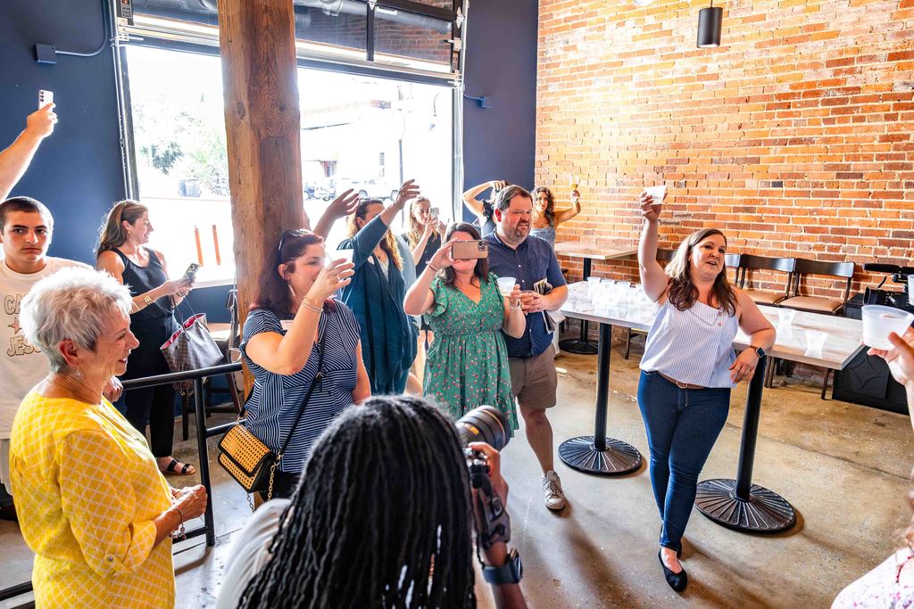 Toast is made after Trade Street Social Ribbon Cutting