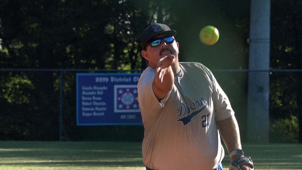 Tournament player throws softball