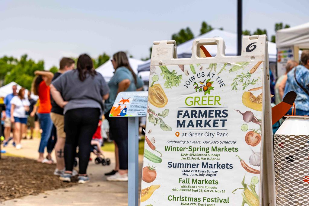 Greer Farmers Market A-Frame Sign with People in Background