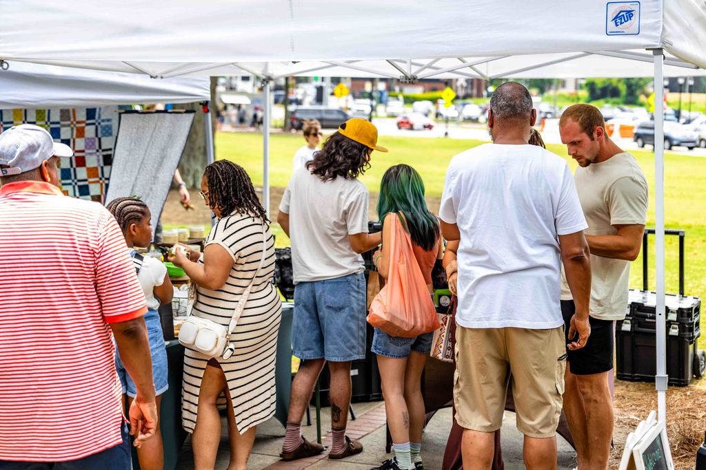 People Browse Vendor's Tent at Greer Farmers Market