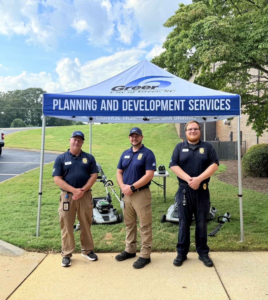 code enforcement officers standing under a tent at the event