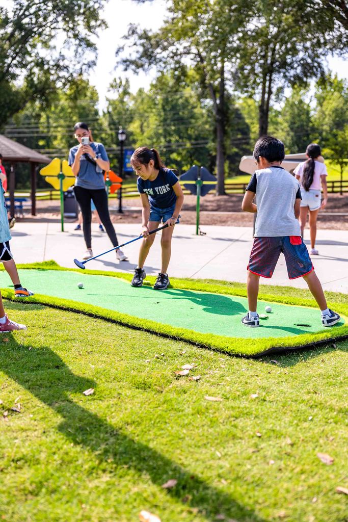 children playing mini golf