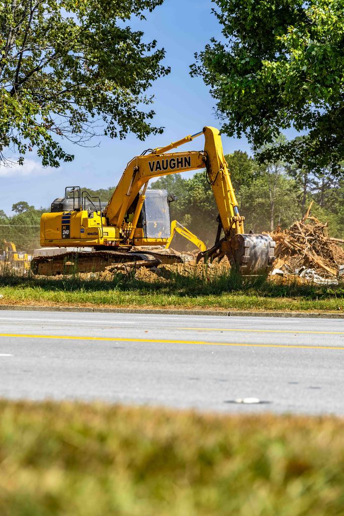machine clearing debris at construction site