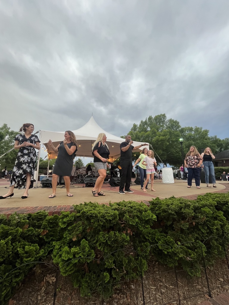 People on stage dancing with band during Tunes in the Park