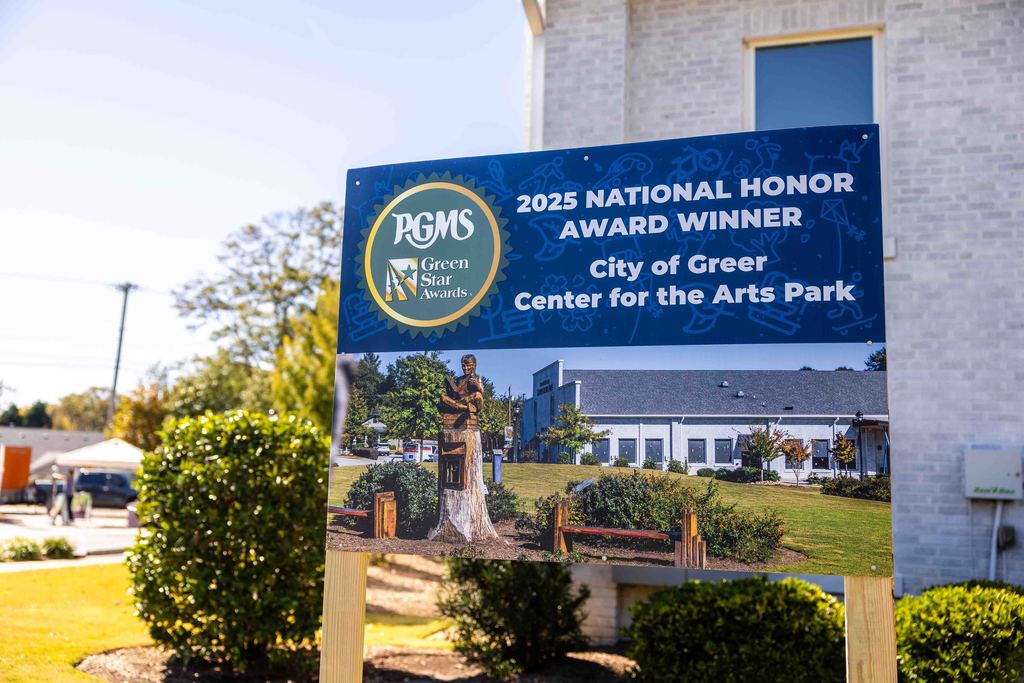 A sign at the Center for the Arts park that says: PGMS 2025 National Honor Award for the City of Greer Center for the Arts Park 