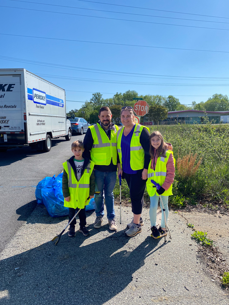 a family posing at the litter cleanup