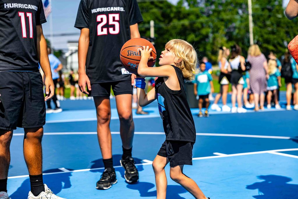 Child shooting a basketball on Stevens Basketball Courts