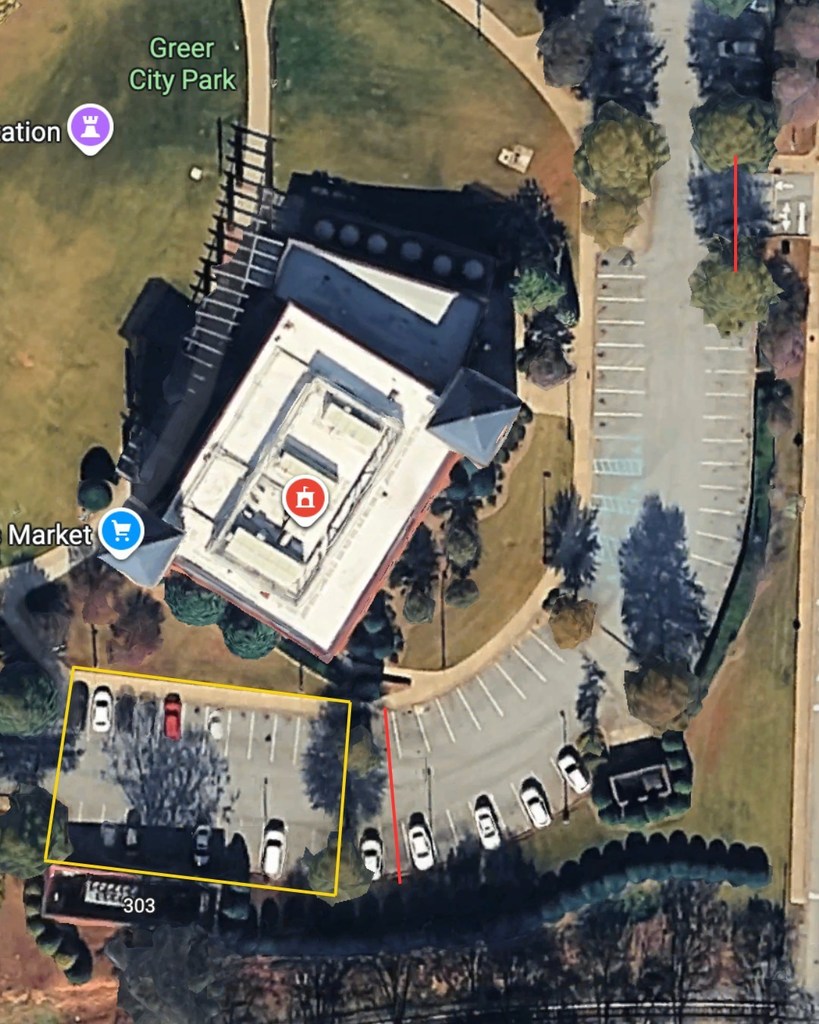 An overhead view of the Greer City Hall parking lot with a red line at the Line Street entrance and one close to the main entrance 
