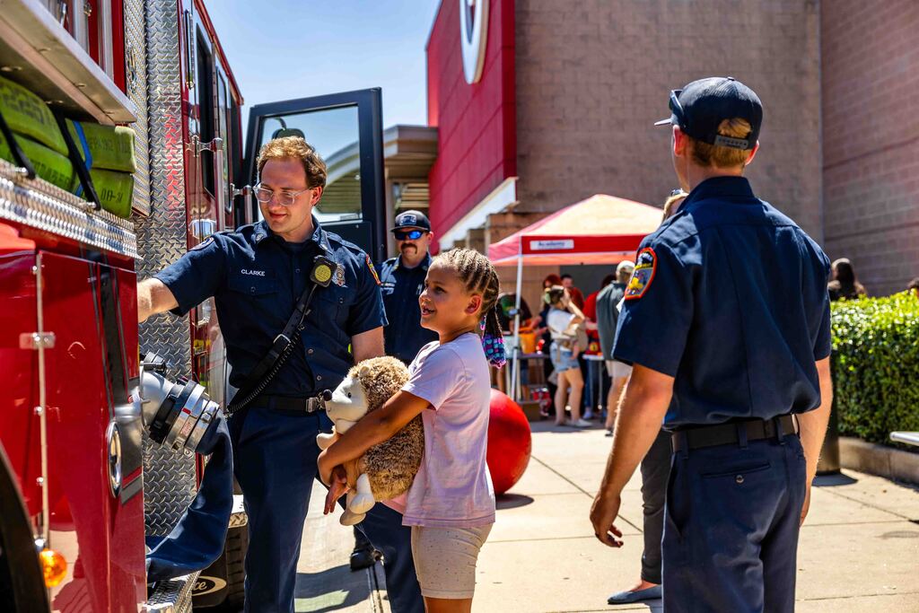 child looking at fire truck 