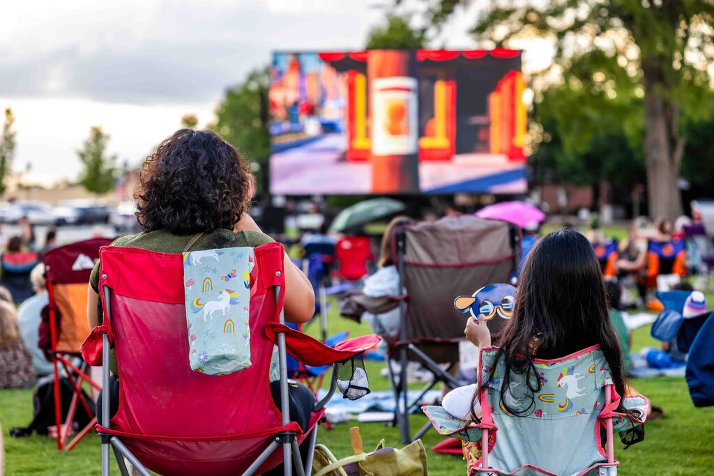 Mother and Daughter watch movie in park