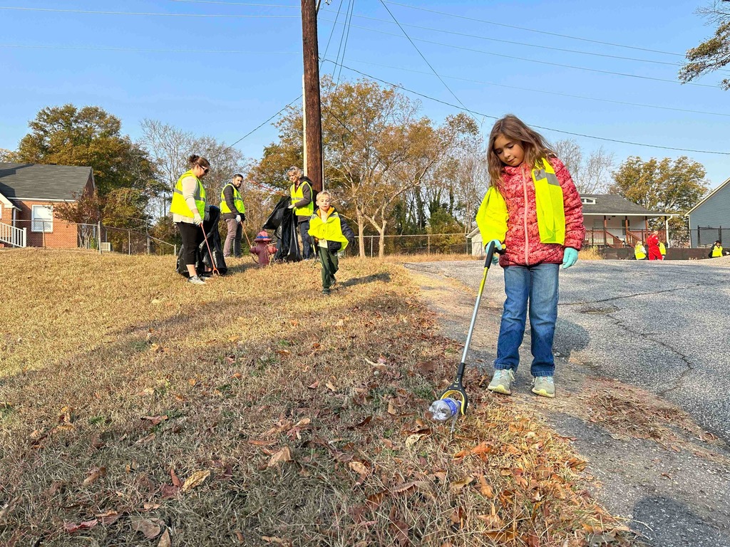 little girl picking up litter