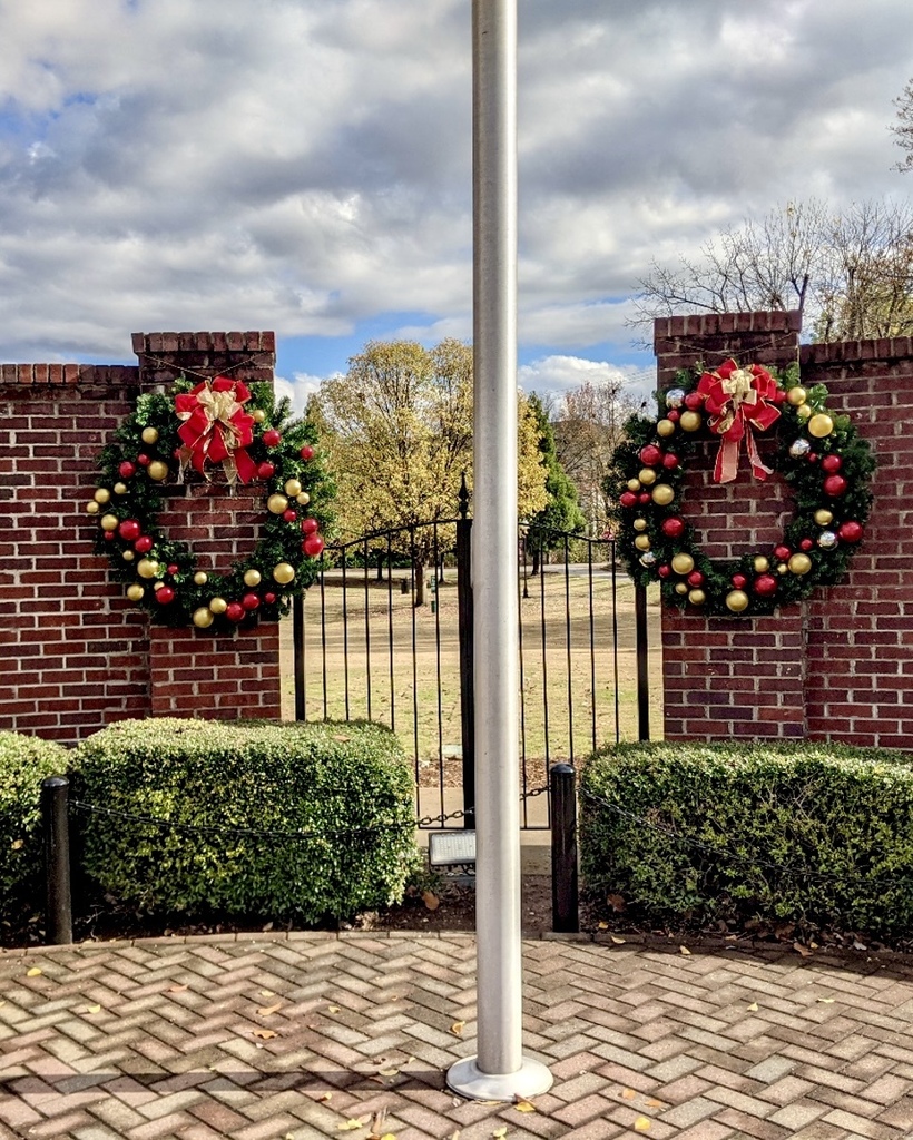 christmas wreaths on brick wall