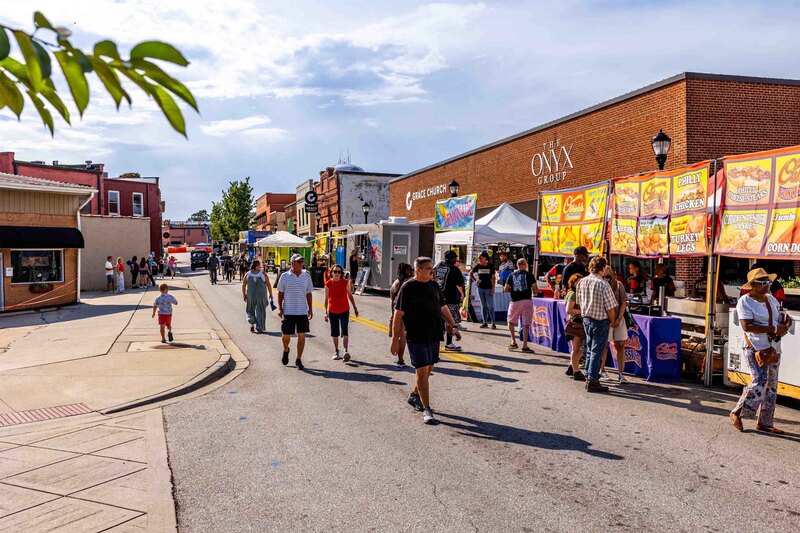 Shot of street with food vendors and people walking