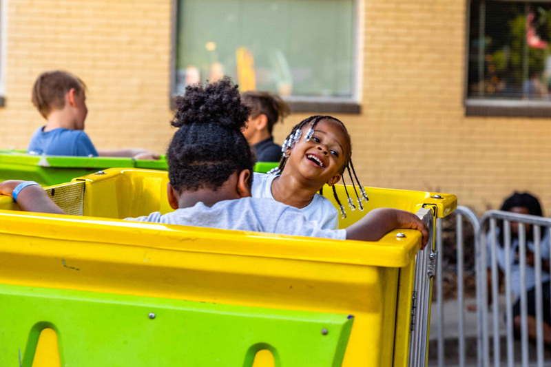 Kids on Yellow Ride Smiling and Laughing