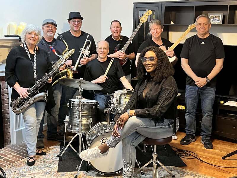 Image shows the band Sweet Soul comprising of a drummer, guitarist, saxophonist, trumpet player, bass player, and singer