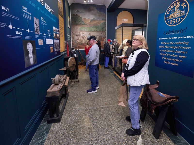 woman reading wall plaque