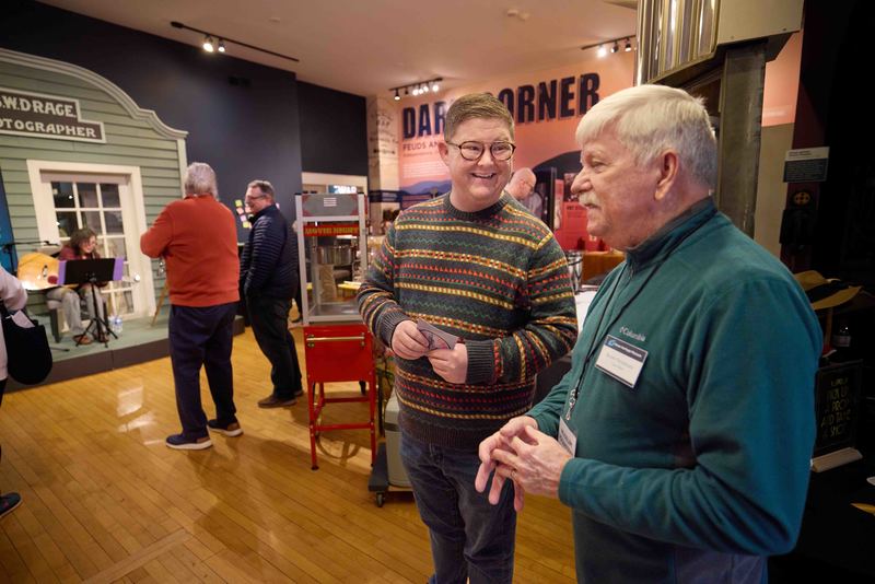 people talking in museum lobby