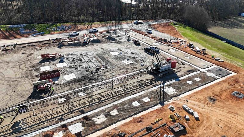 Drone shot of active construction site with large crane