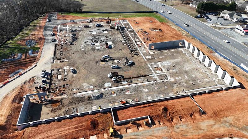 Drone shot of active construction site with large crane