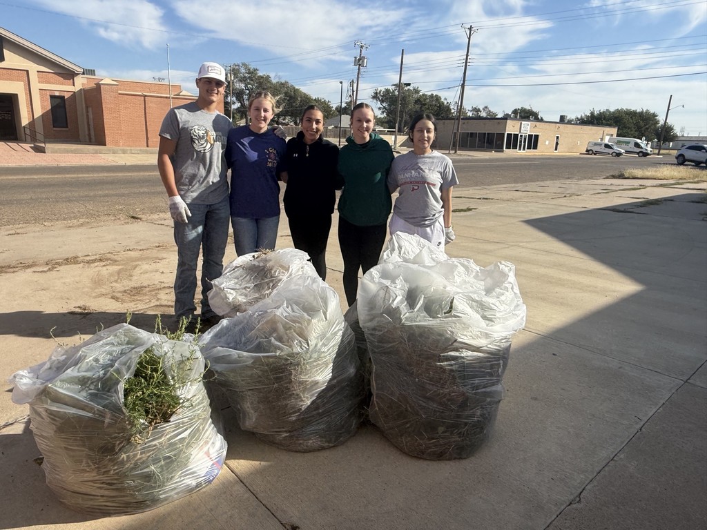 Guymon HS Interact Club on Clean-Up day with 3 large bags of weeds