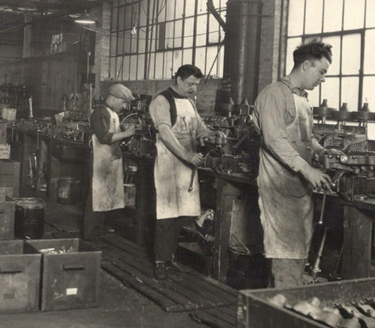 factory workers building the washing machines