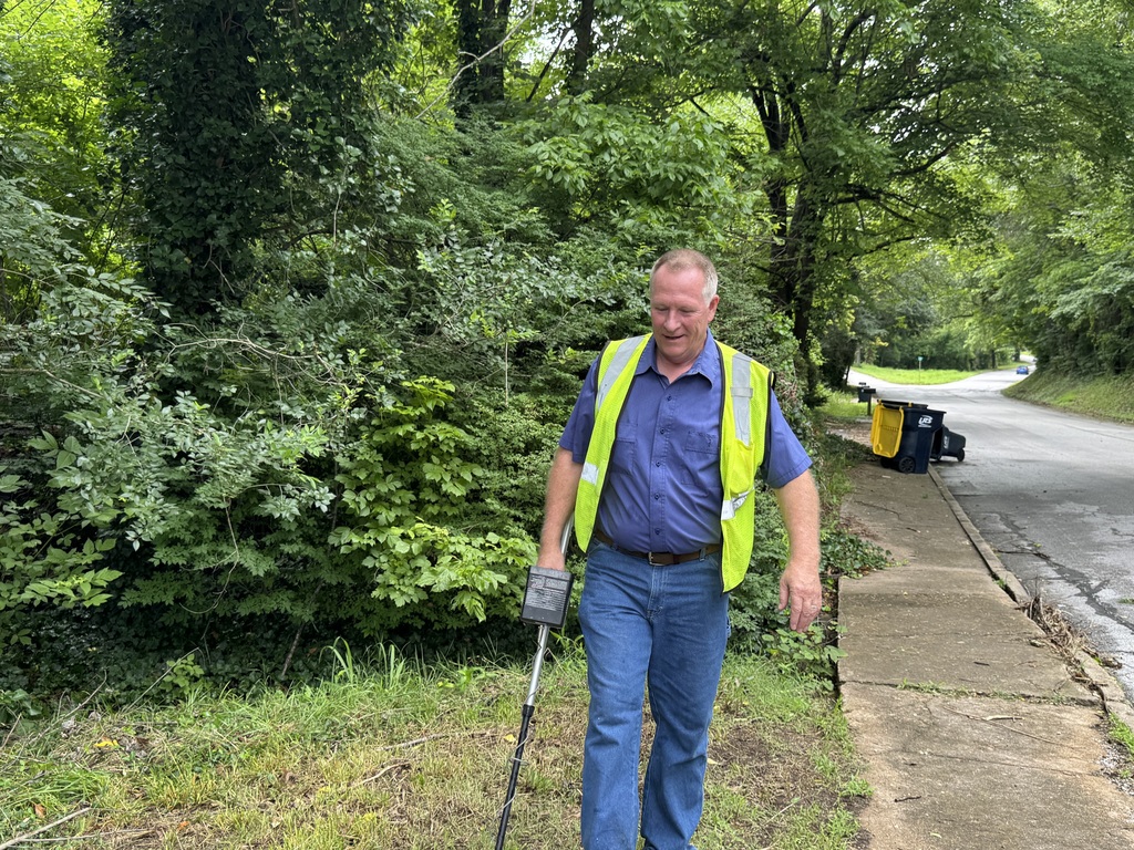 Carl Rine searching for a manhole
