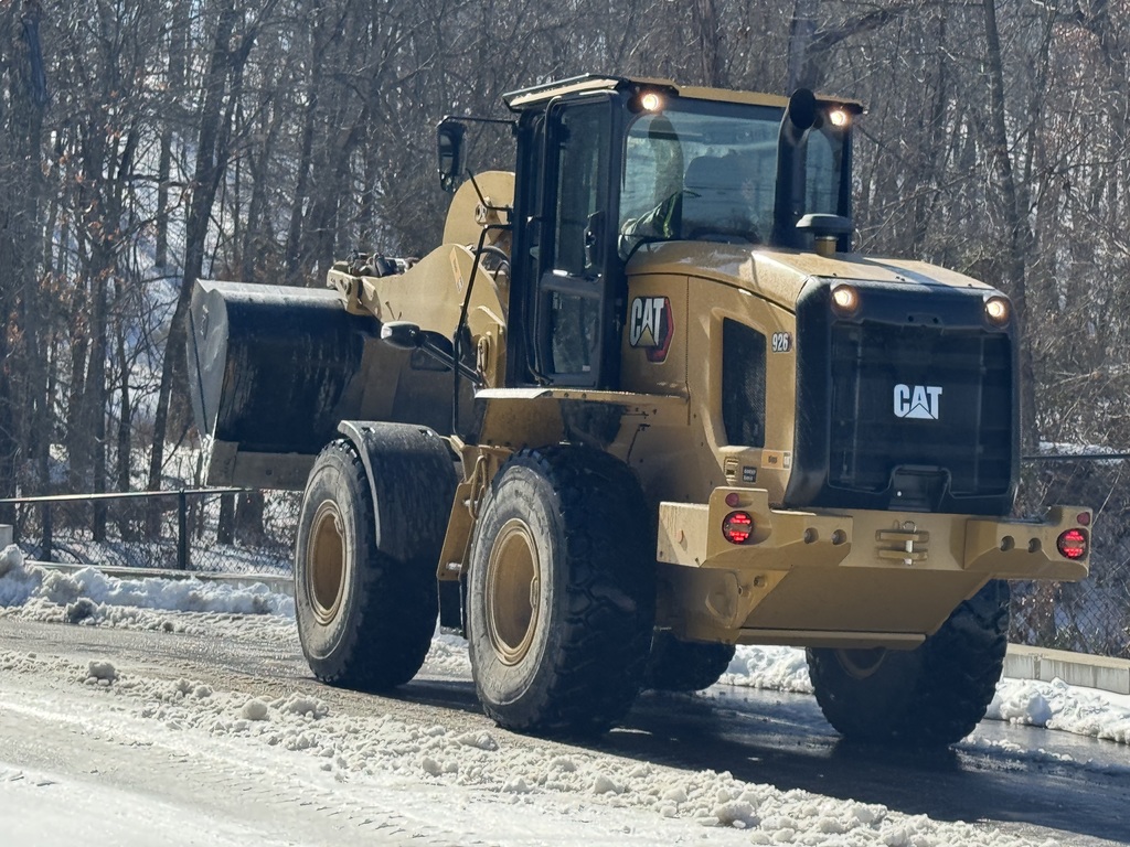 Tractor clearing snow/ice.