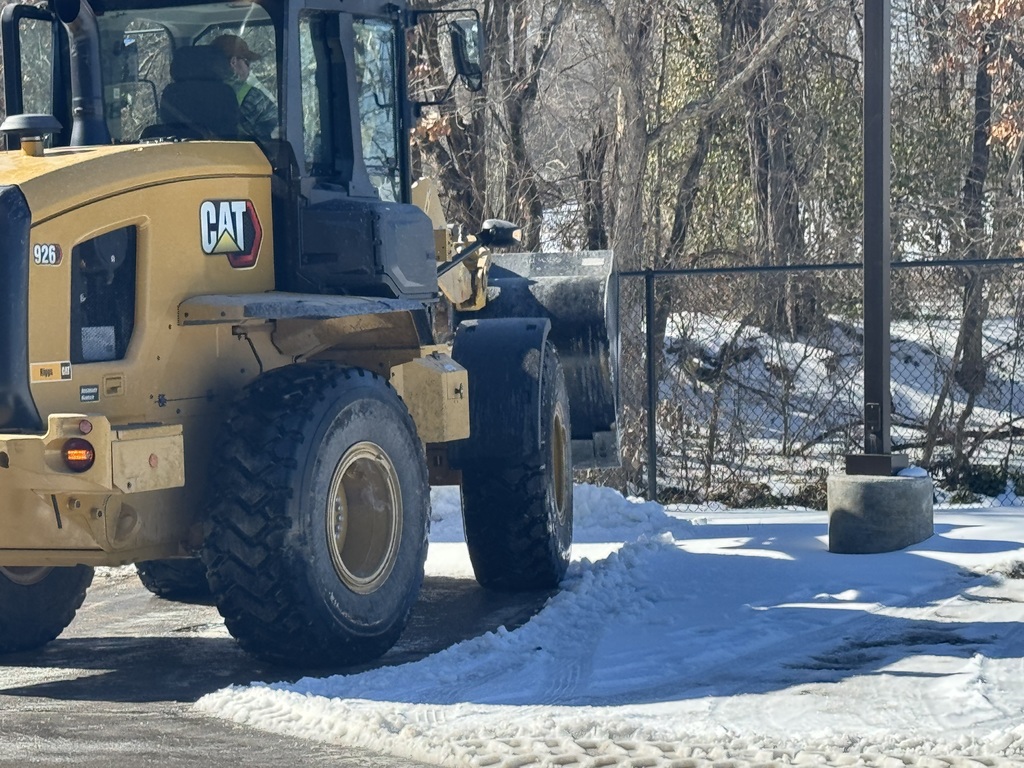 Tractor clearing snow/ice.