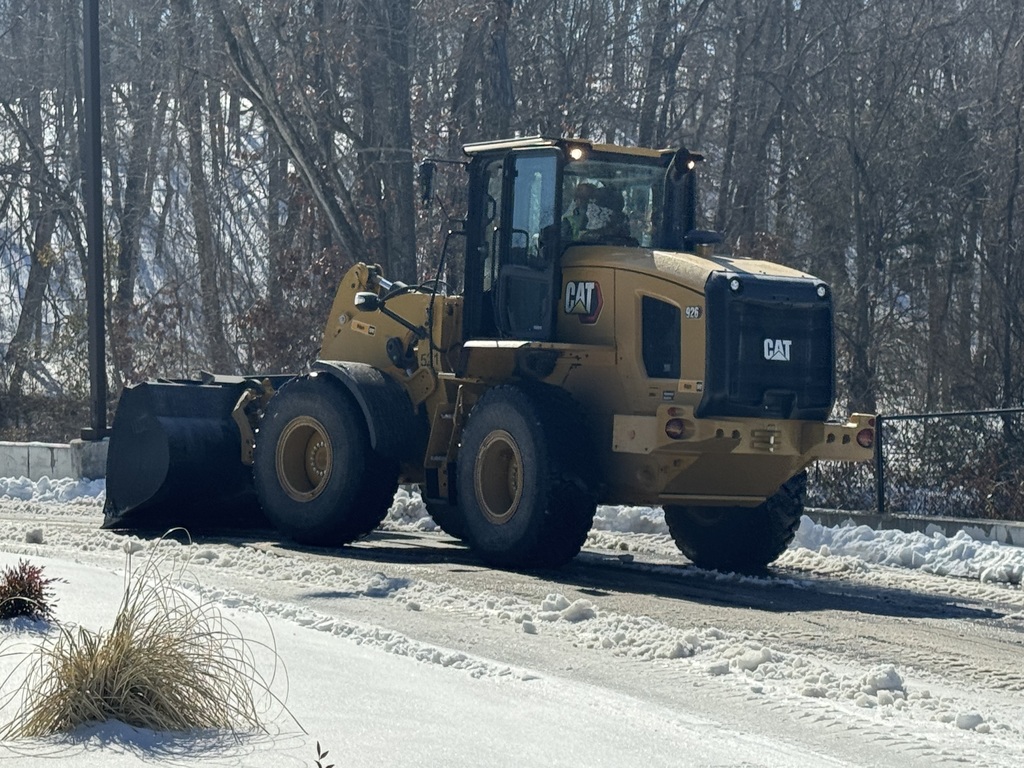 Tractor clearing snow/ice.