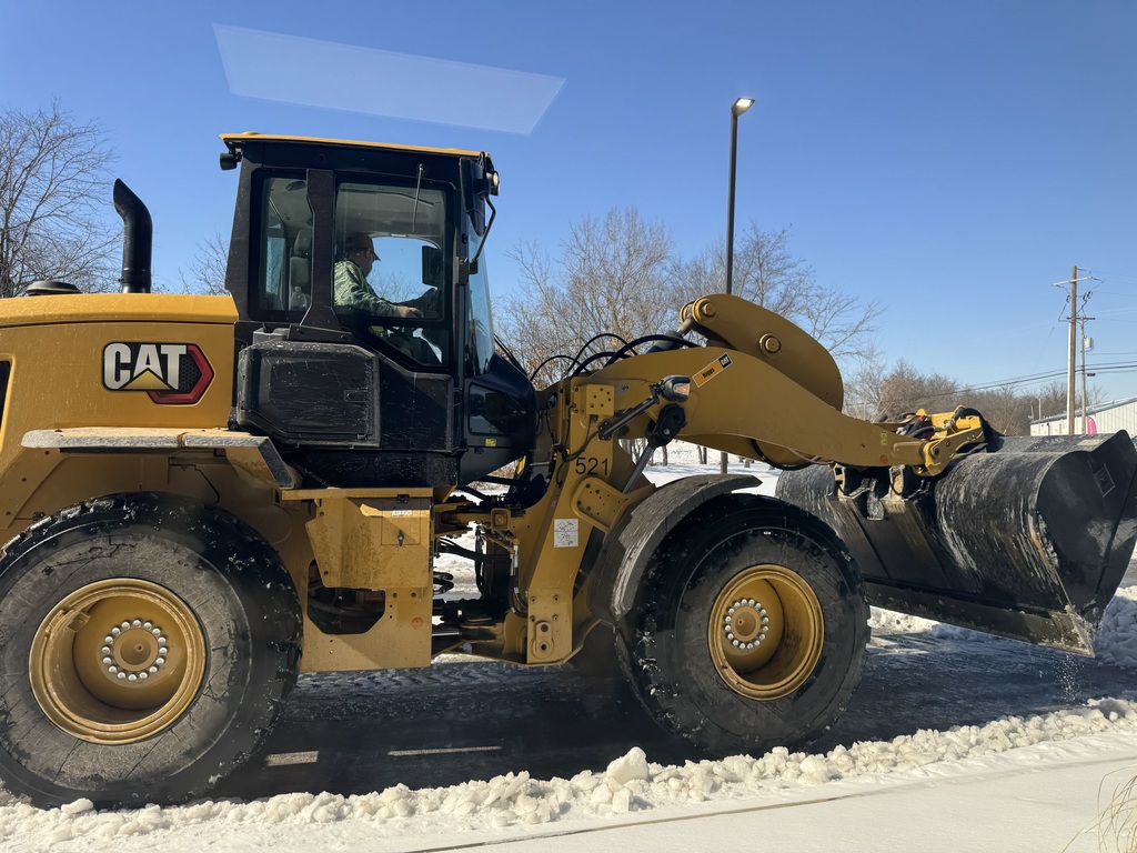 Tractor clearing snow/ice.