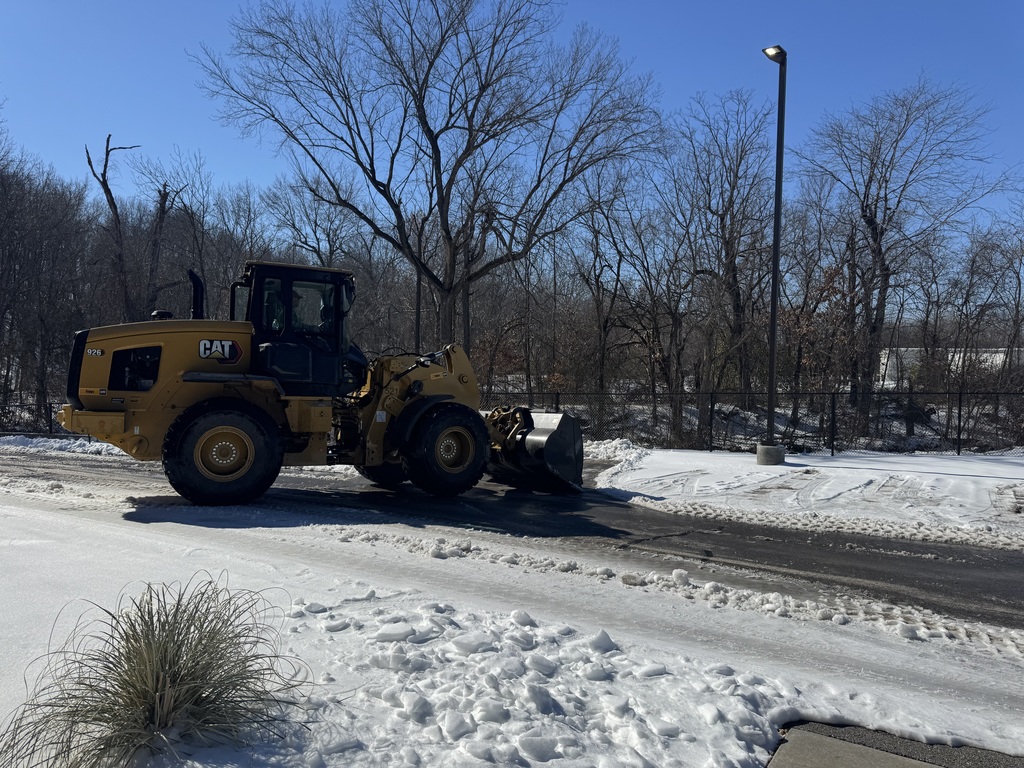 Tractor clearing snow/ice.