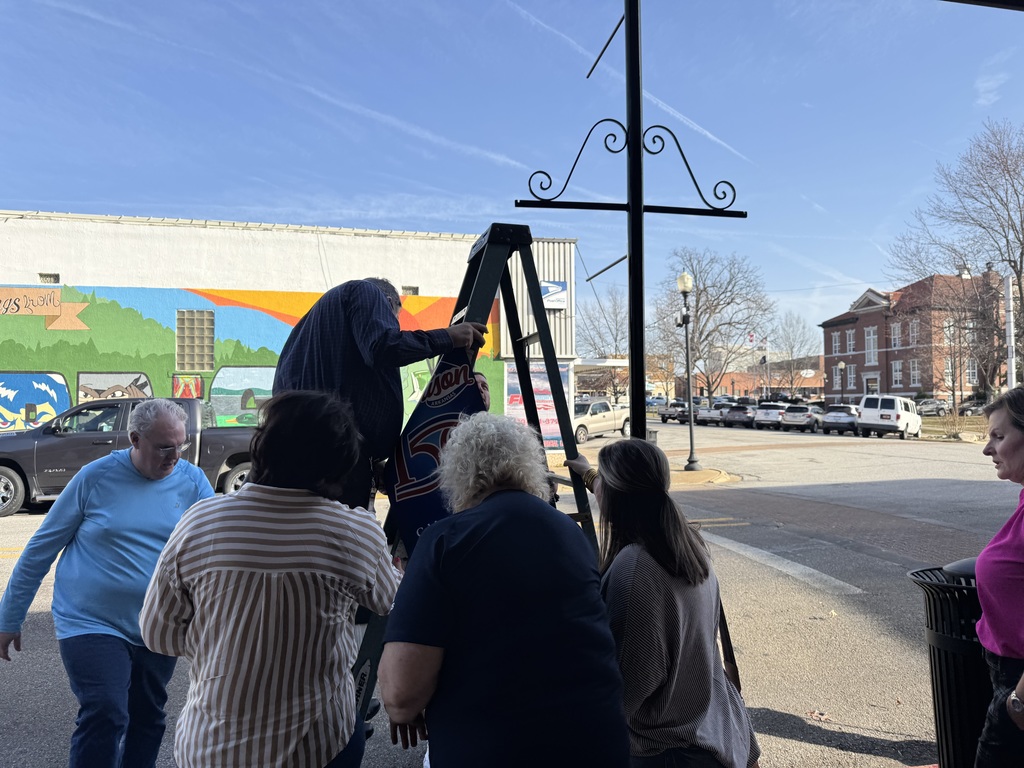Harrison150 hanging a banner.