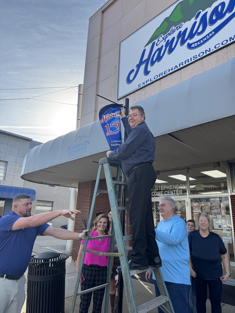 Harrison150 hanging a banner.